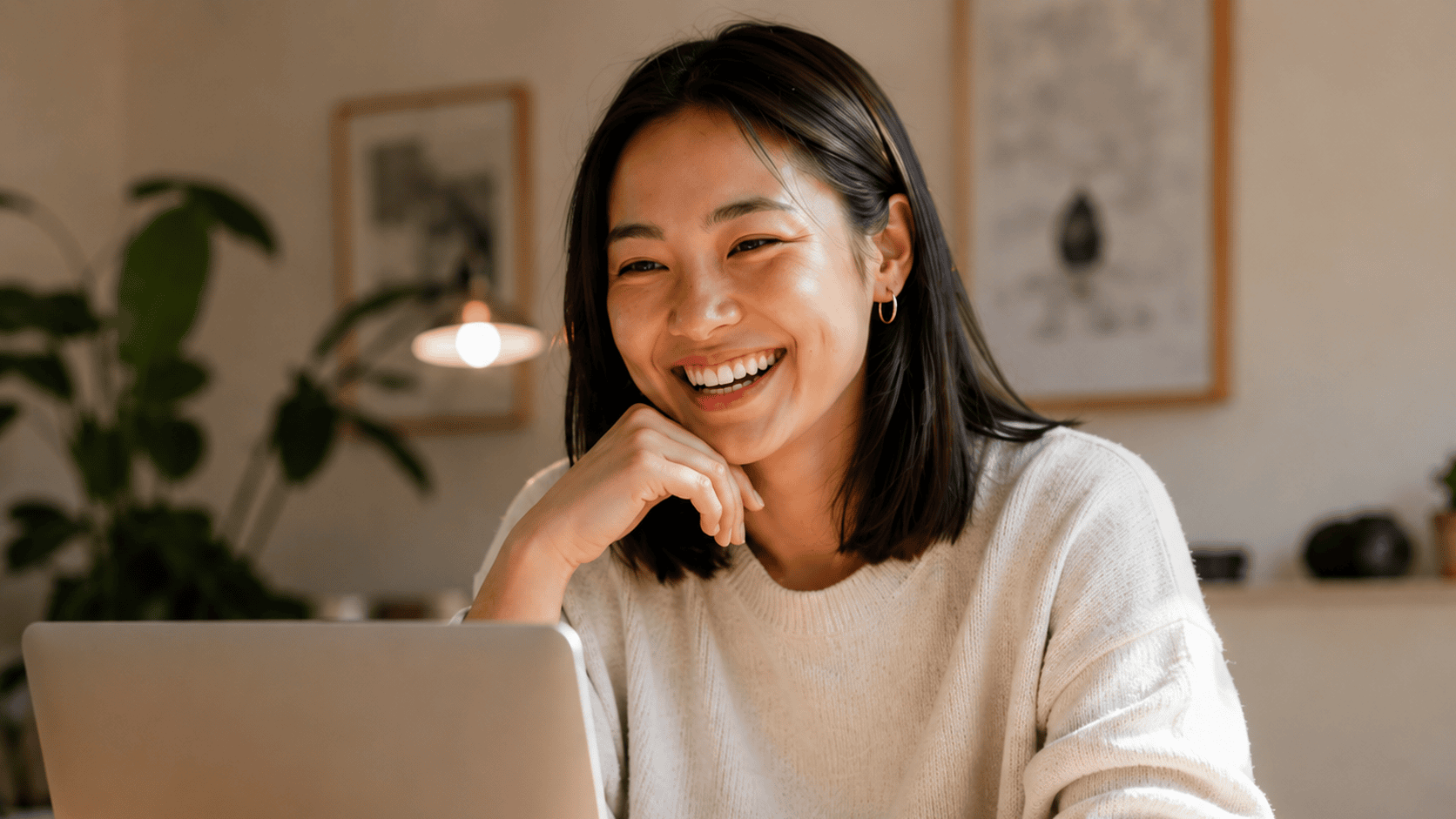 Smiling employee at a laptop during a live online language lesson